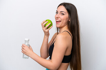 Young girl isolated on white background with an apple and with a bottle of water