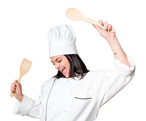 Young cook woman holding wooden spoon and fork isolated
