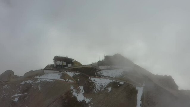 Tracking drone video showing low level clouds covering the Dolomites, Italy 