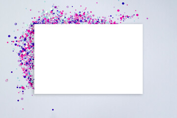Fototapeta na wymiar Blank square rectangular card and pink and purple confetti. Template Layout. Top view. Mockup