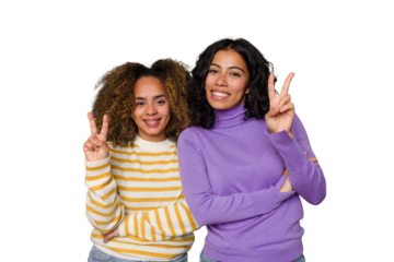 Two female friends isolated in studio showing number two with fingers.