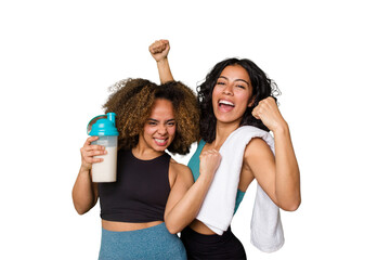 Fototapeta na wymiar Two best friends are ready to go to the gym, one of them holds a protein shake, raising fist after a victory, winner concept.