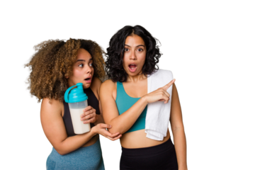 Two best friends are ready to go to the gym, one of them holds a protein shake, pointing to the side