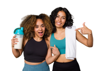 Two best friends are ready to go to the gym, one of them holds a protein shake, person pointing by hand to a shirt copy space, proud and confident