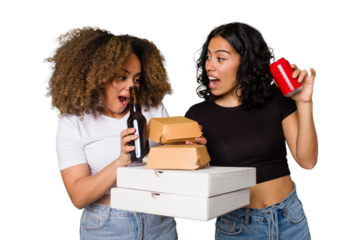 Two young women, one Latina and one with Afro hair, laugh as they hold pizzas and burgers from a recent delivery. 