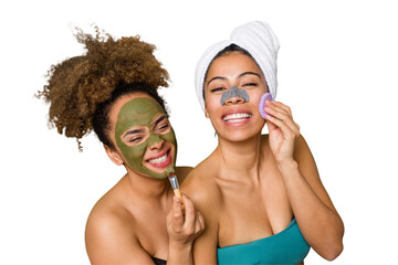Two friends pamper themselves with facial treatments for a relaxing spa day at home, with laughter and enjoyment. Nourishing their skin for a glowing, confident look.