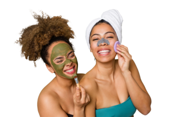 Two friends pamper themselves with facial treatments for a relaxing spa day at home, with laughter and enjoyment. Nourishing their skin for a glowing, confident look.