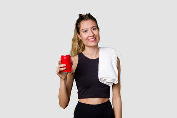 Young sportswoman holding sugary drink with a look of disapproval.