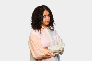 Fototapeta premium Young african american curly woman isolated suspicious, uncertain, examining you.