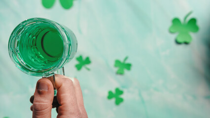 Placing a green beer glass on flat layer background Saint Patrick day
