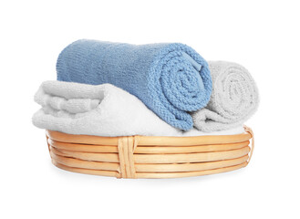 Wicker basket with rolled bath towels isolated on white