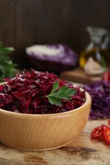 Fotobehang Tasty red cabbage sauerkraut with parsley on wooden table, closeup © New Africa