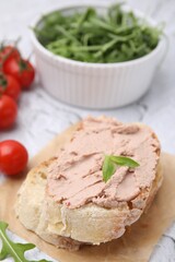 Delicious liverwurst sandwich with basil on white textured table