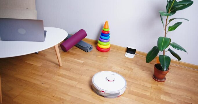 Robot vacuum cleaner performs automatic cleaning of the house at a certain time. Smart home concept. Copy space