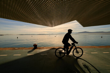 Santander Bay seen from the Botín Center while a cyclist against the light circulates with an...
