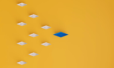 Top view of Paper boat leads blue followed by other white boat on a yellow background. Social media or internet followers concept.