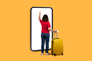 Back view of brunette woman tourist using big smartphone, mockup
