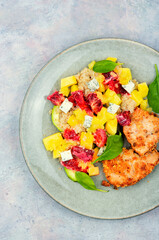 Meat salad with citrus fruits, mango, cheese and quinoa