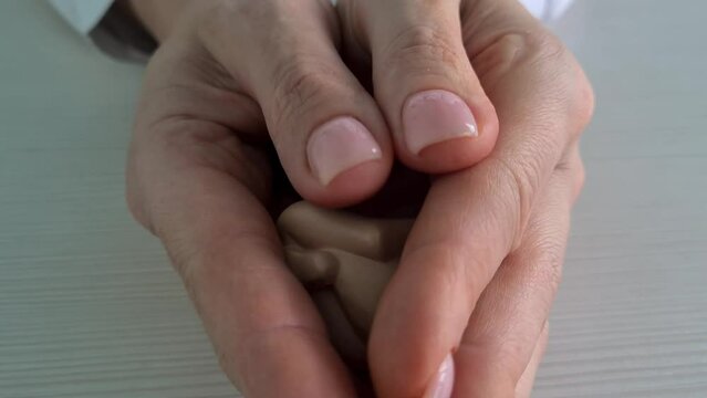 Fetus is embryo of child on hand of gynecologist doctor. Childbirth and surrogacy and IVF concept