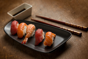 sushi sashimi with chopstick over wooden background