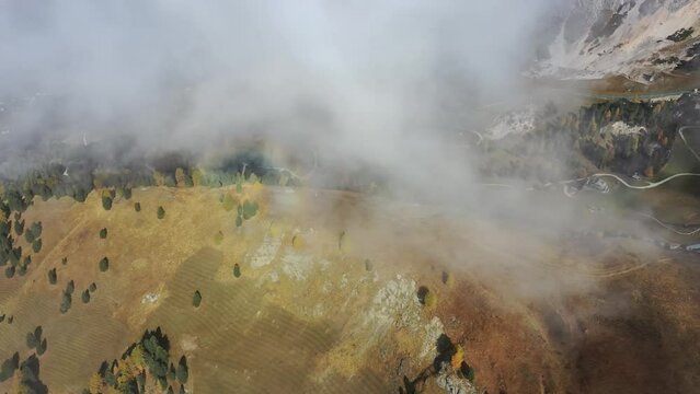 Tracking drone video showing low level clouds covering the Dolomites, Italy 