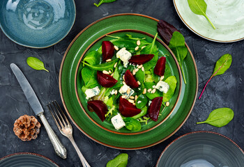 Fresh salad with beets, cheese and greens.