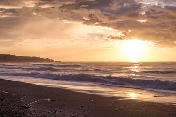 Fototapeta na wymiar Panaroma with beautiful sunset over calm ocean and crescent bay