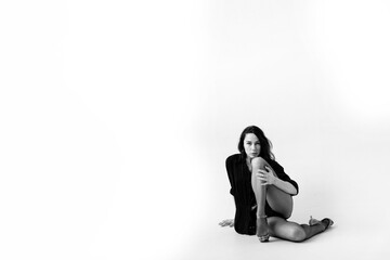 Passionate latina dancer in the studio is dancing in small black dress