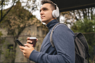 Fototapeta premium One man young adult male stand at public transport bus station waiting