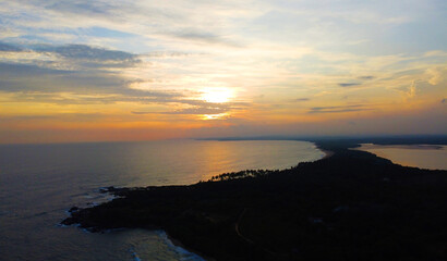 Aerial view of the tropical sea sunset. Beautiful evening wallpaper for tourism and advertising. Asian landscape, drone photo