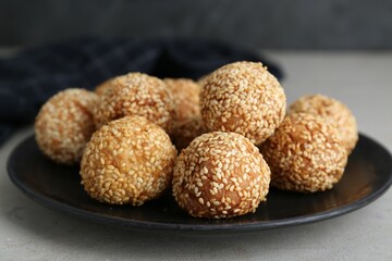 Delicious sesame balls on light grey table, closeup