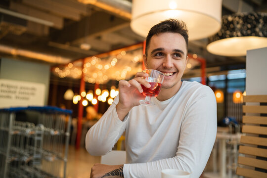 One Man Young Adult Caucasian Male Sit Alone At The Table At Cafe Or Restaurant Drink Fruit Sparkling Water Copy Space Real People Happy Smile