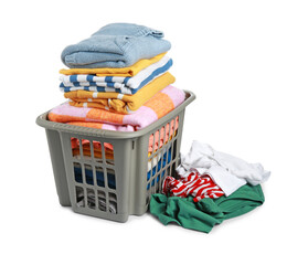 Plastic laundry basket and clean clothes isolated on white