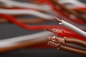 New colorful electrical wires on blurred background, closeup. Space for text