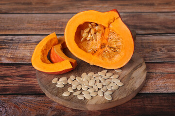 Fresh pumpkin and vegetable seeds on wooden table