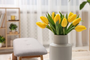 Spring interior. Bouquet of beautiful yellow tulips in living room, space for text