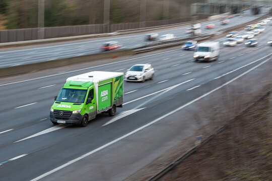 Chorleywood, UK - February 25, 2023: Little home delivery van belonging to food store Asda in motion on the british motorway M25