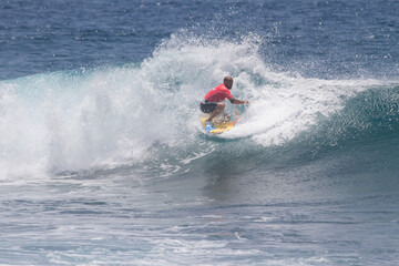 TENERIFE, SPAIN 11- AUGUST- 2013: man doing different maneuvers on a wave during a bodyboarding competition
. Boy competing in men's bodyboard championship. Tenerife, Canary Islands, Spain
