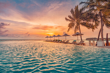 Outdoor luxury sunset over infinity pool swimming summer beachfront hotel resort, tropical landscape. Beautiful tranquil beach holiday vacation background. Amazing island sunset beach view, palm trees