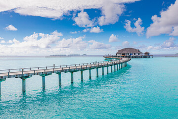 Fototapeta na wymiar Best tranquil Maldives island, luxury over water villas resort aerial view. Beautiful sunny sky. Sea bay lagoon beach background. Summer vacation holiday. Paradise shore exotic landscape pristine blue