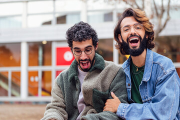 couple of gay men laughing surprised, concept of freedom and love between people of the same sex, copy space for text