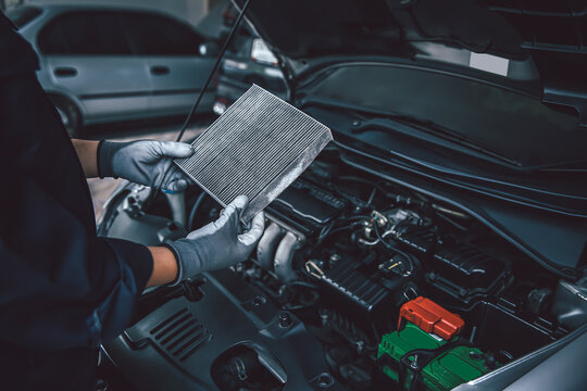 Car air conditioner system maintenance, Hand mechanic holding car air filter to check for clean dirty or fix repair heat have a problem or replace new or change filter.
