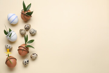 Festively decorated Easter eggs on beige background, flat lay. Space for text