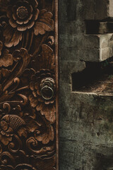 Carved wooden doors and a stone wall in Bali, Indonesia