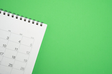 close up of calendar on the green table background, planning for business meeting or travel...