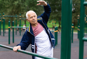 Senior man doing warming up exercises