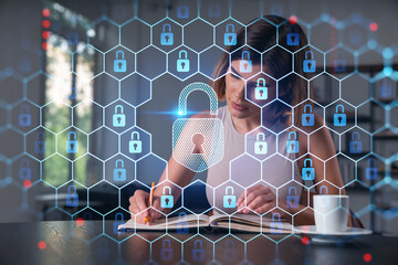 Smiling woman in casual wear taking notes in notebook at office workplace with coffee cup. Concept of distant business education, information technology, dreaming, thinking. Lock drawings