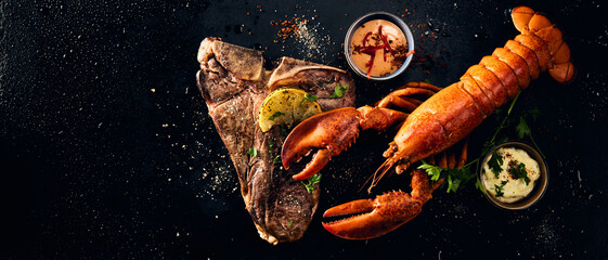 Grilled lobster and meat on black background