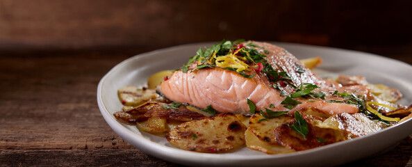 Delicious salmon with potatoes on plate
