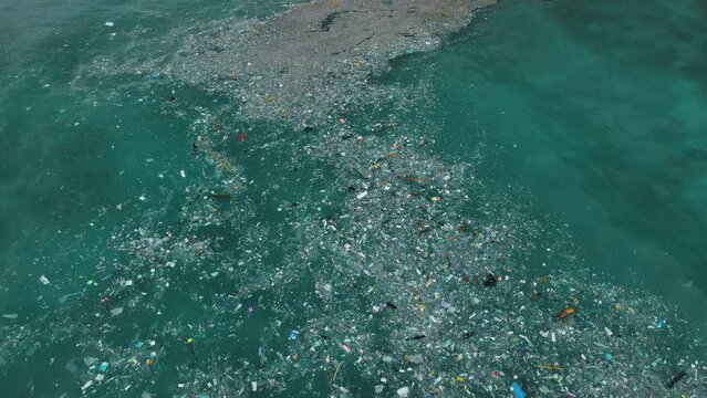 Indian ocean and plastic trash, aerial drone view. Pollution by plastic rubbish